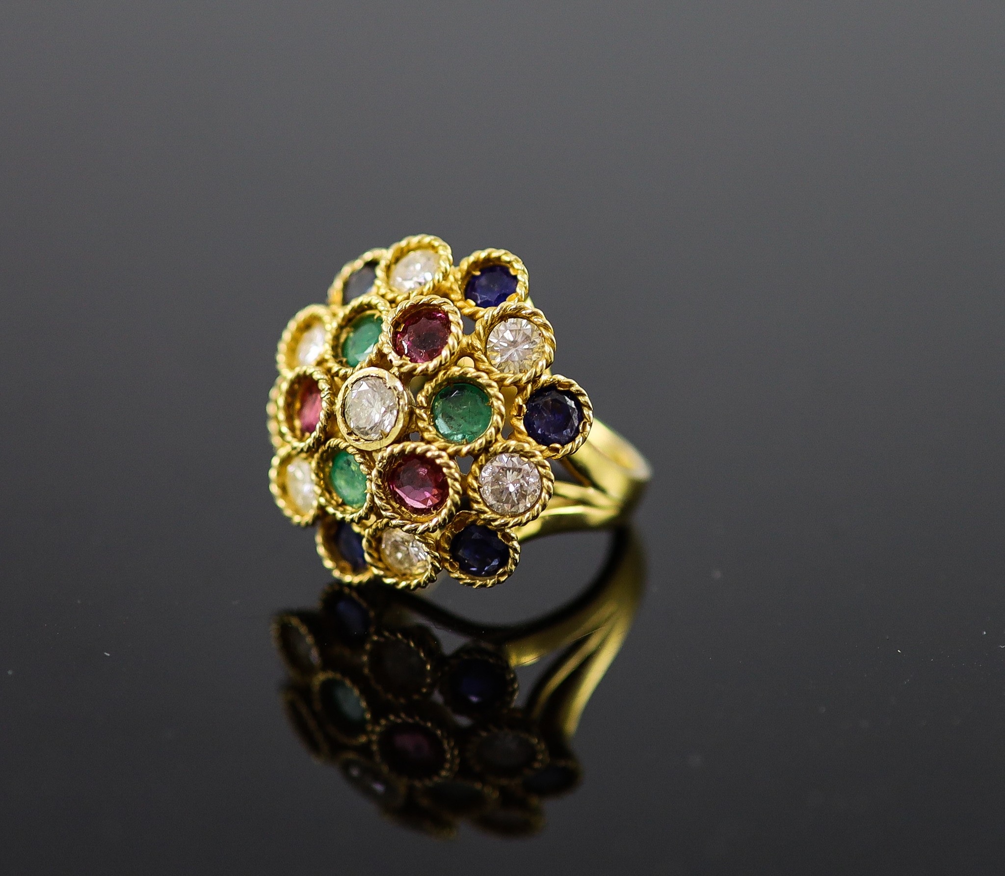 A continental gold (stamped 850) and multi gem set circular dress ring